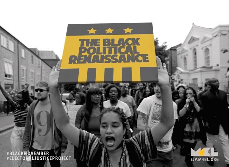 People marching with a woman holding up a sign that says The Black Political Renaissance