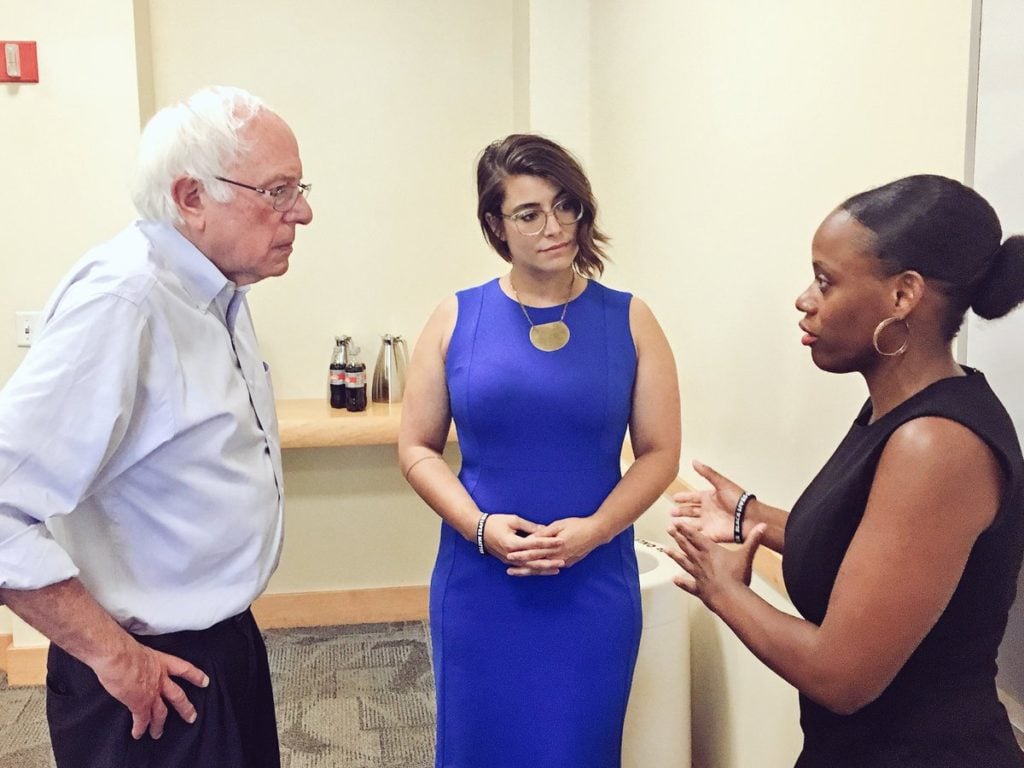 Bernie Sanders talking with 2 women