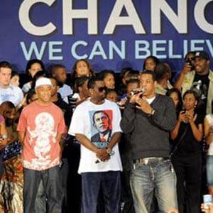 Group of people standing front of a large banner that says Change We Can Believe In