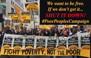 Image of people at a protest with signs that say fight poverty, not the poor