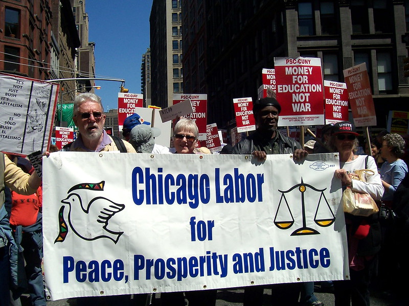 People holding a banner that says "Chicago Labor for Peace, Prosperity and Justice"