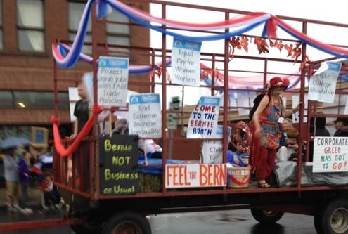 Photo of the Bernie float at a parade with a large sign that says "Feel the Bern"