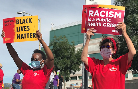 NNU members carrying signs reading Black Lives Matter and Racism Is a Public Health Crisis.