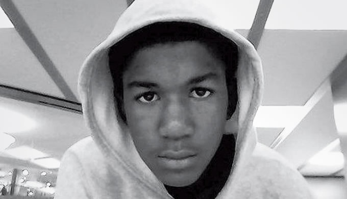 Black and white photo of Trayvon Martin in a white hoodie