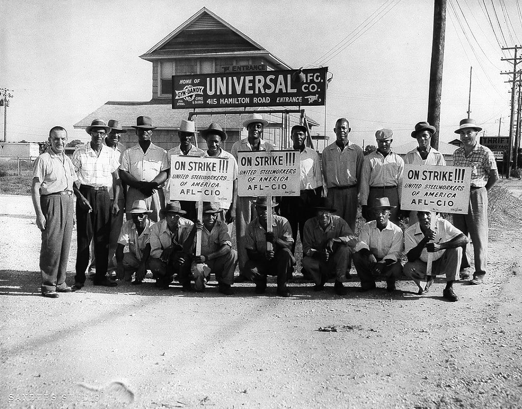Black and white picture of a group of men holding picket signs