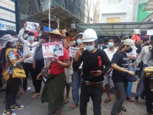 People wearing hard hats protesting in Myanmar
