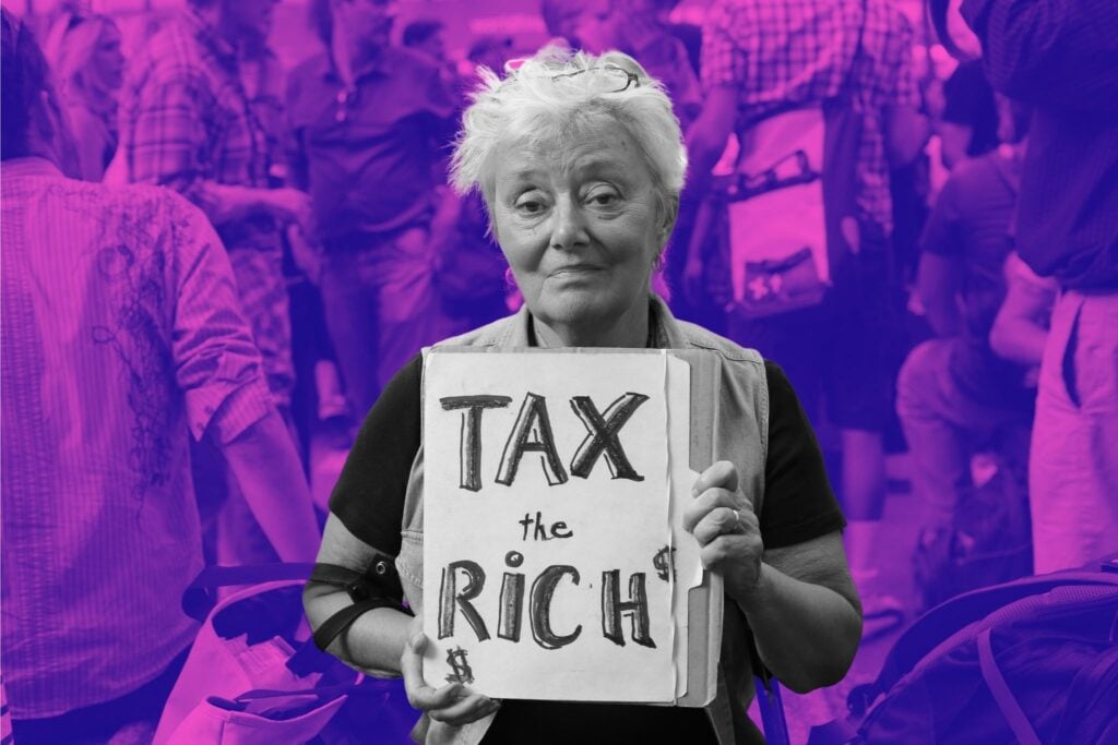 Woman at Occupy Wall Street Rally holds sign saying "Tax the Rich"